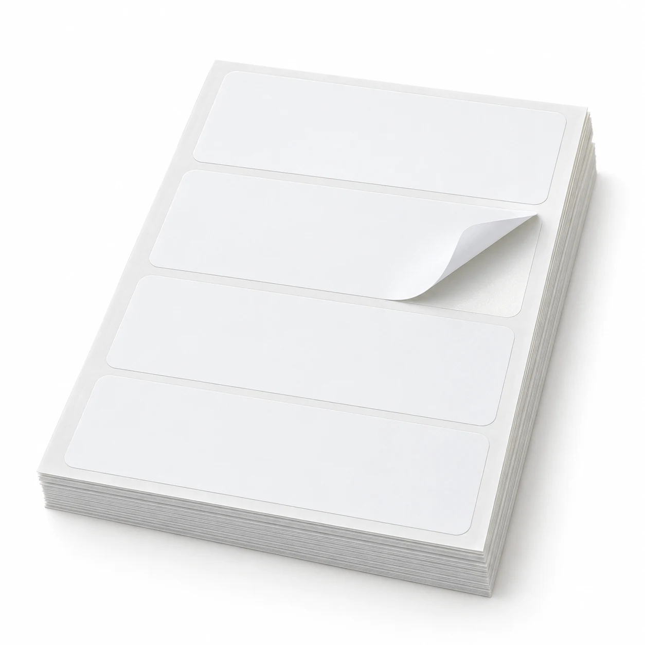 Stack of white removable label sheets with the top label lifted at a corner