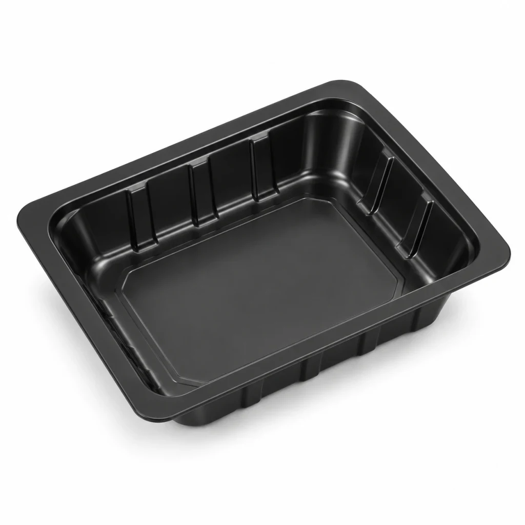 Black vacuum skin packaging tray, empty, seen from the front corner
